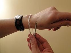 holding bracelet around wrist to check fit holding bracelet around wrist to check fit