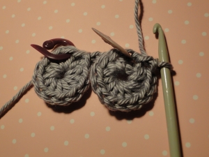 Two wheels crocheted, joined by a chain