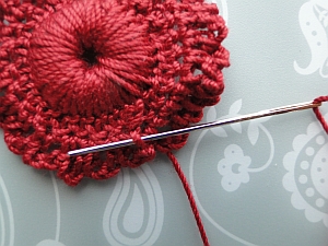 Weaving in the end through the back of the first loop. Weaving in the end through the back of the first loop.