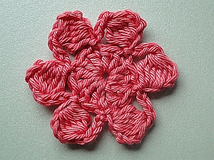 Salmon pink crochet flower with bobbles for petals