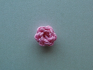 Tiny pink circular flower