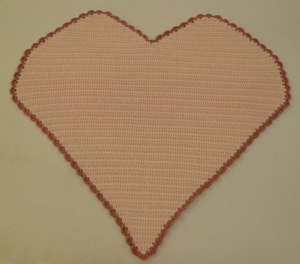 Heart blanket with contrasting edging.