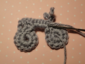 Weaving first end in along wrong side of crossbar