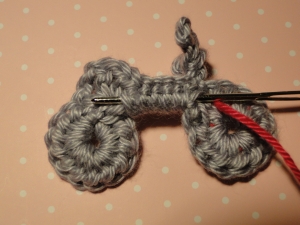 Bringing contrasting yarn across wrong side to next wheel