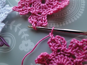 Hook into center chain of other flower Hook into center chain of other flower