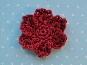 Dark red thread weight yarn used for flower