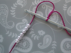 six pearl beads on yarn and slip knot on hook