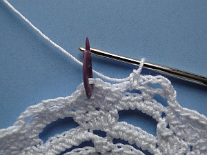 Stitch marker shows where to work the stitch into the center of the crown