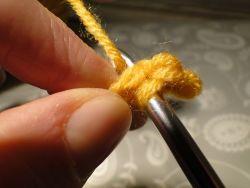 Pulling yarn through loops