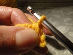 Yarn pulled through two loops on hook