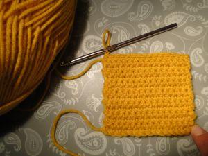 A yellow single crochet stitch square A yellow single crochet stitch square