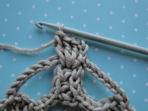 Four stitches in top of cog.