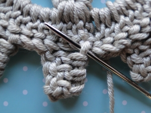 Weaving into the back of the piece.