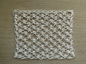 White thread yarn used to make a bigger square